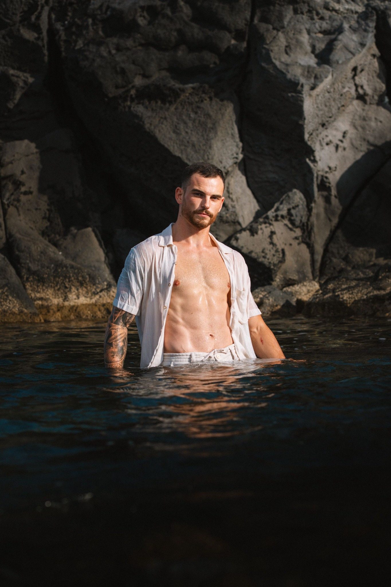 Joris dans l’eau devant des rochers
